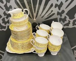 A Royal Grafton part tea set, white and yellow with richly gilded details.