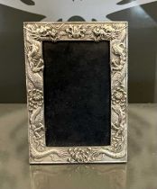 A modern Chinese white metal photograph frame with dragon borders, 18cm x 12.5cm.