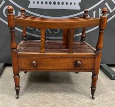 A 19th century mahogany three division canterbury with single frieze drawer, raised on four turned