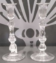 A pair of early 20th century cut glass candlesticks.