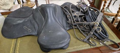 A black leather horse saddle, together with bridle/ reigns.