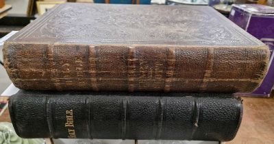 A late 19th century black leather-bound volume with gilt-edged pages of the Holy Bible containing