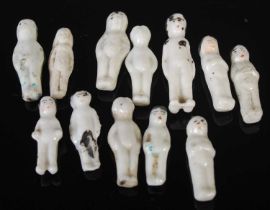 A collection of twelve assorted frozen Charlotte ceramic pudding dolls, approximately 2.8cm long.