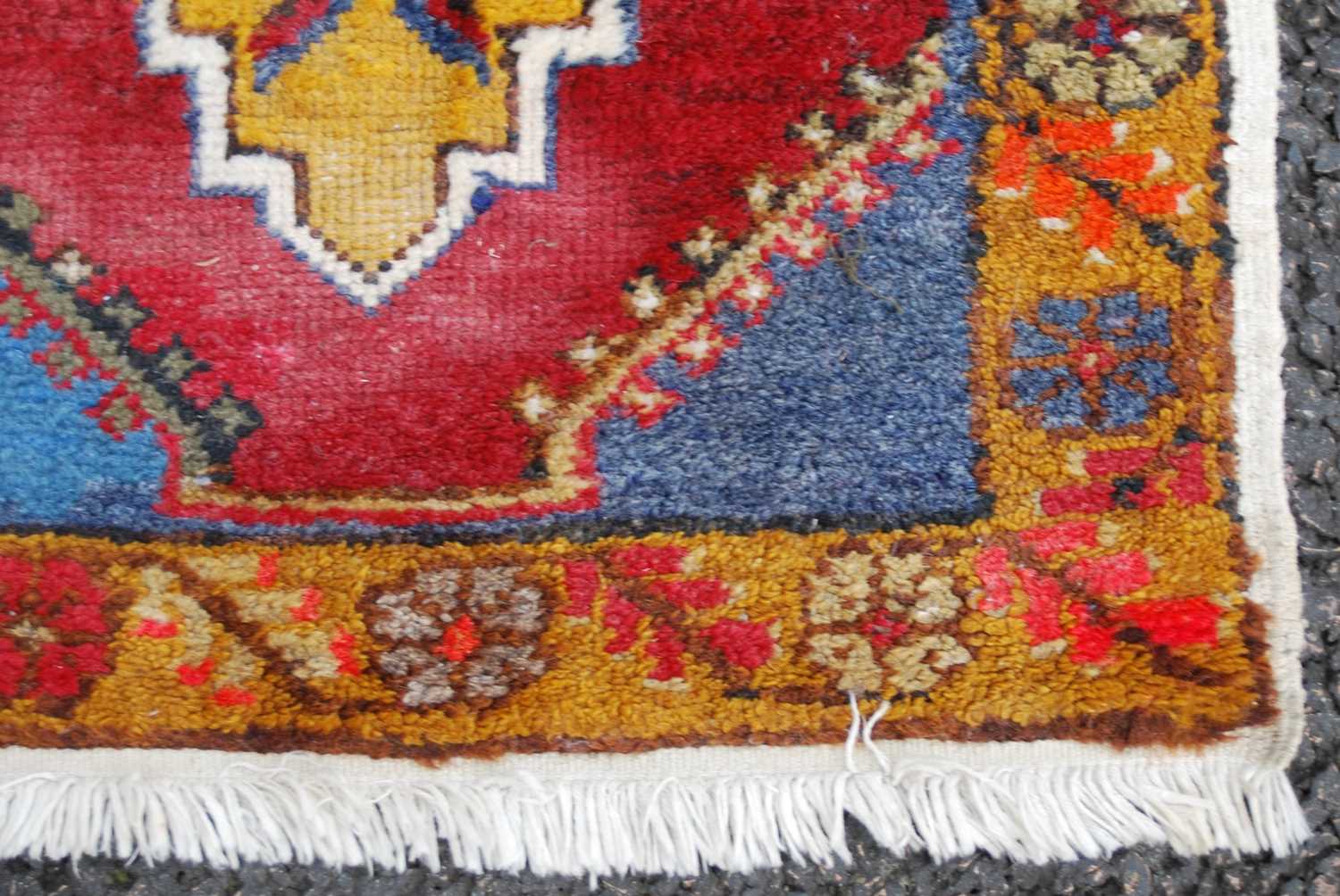 A small Persian rug/ mat, 20th century, the madder ground centred with an ochre-coloured medallion - Image 3 of 4