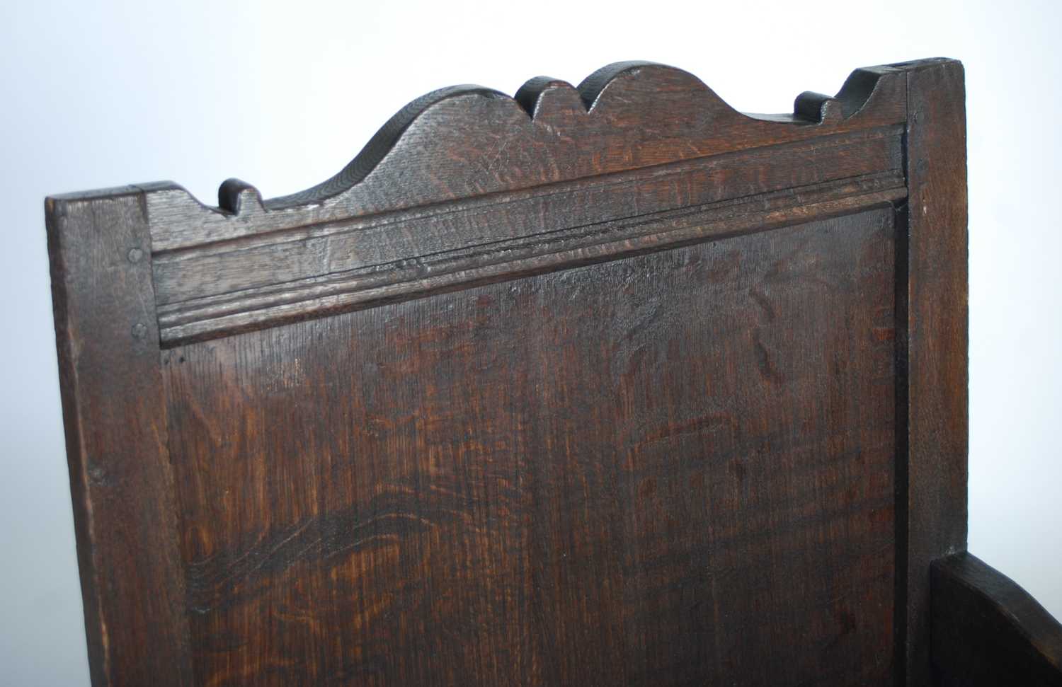 An 18th century oak lambing chair, the shaped top rail above a rectangular panelled back, the box - Image 2 of 6