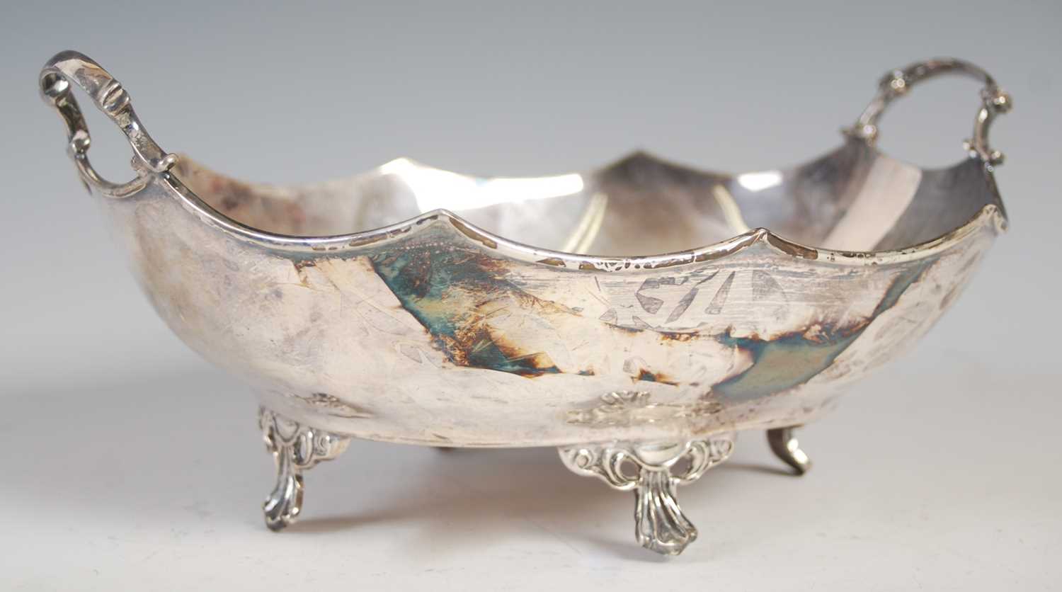 A George V silver twin-handled bowl, Sheffield, 1927, makers mark of H.A, oval-shaped with wavy rim,