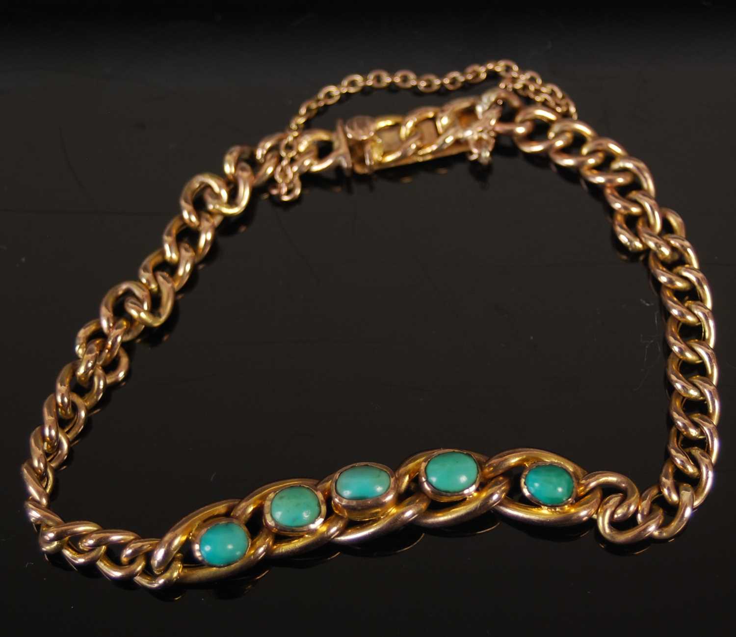 A yellow metal and turquoise bracelet, set with a row of five cabochon cut turquoise, stamped ' - Image 2 of 4