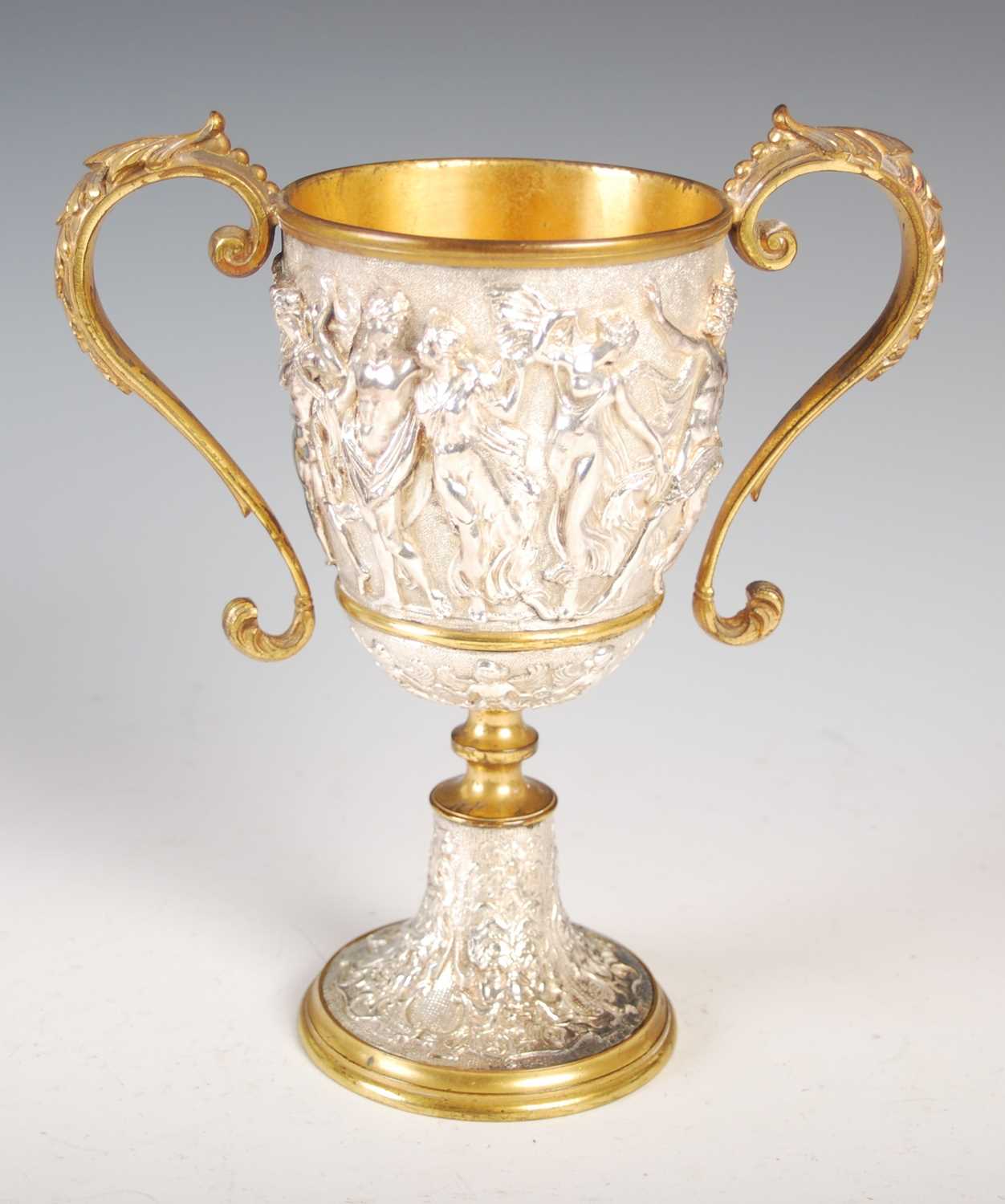 A Victorian silver-plated and gilt metal twin-handled cup, decorated in high relief with a frieze of - Image 5 of 7