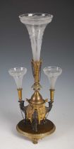 A late 19th century silver plated and gilt metal camel epergne, centred with a wheel-cut glass