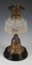 A late 19th century brass and clear glass paraffin burning oil lamp, 38cm high.