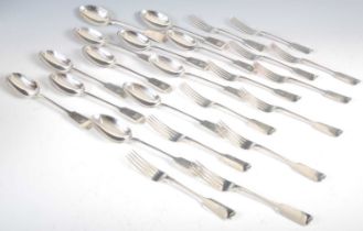 A composite suite of Victorian silver flatware, fiddle pattern, comprising twelve table forks,