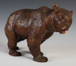 A late 19th / early 20th century Black Forest carved wooden model of a bear, with painted details
