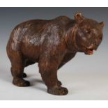 A late 19th / early 20th century Black Forest carved wooden model of a bear, with painted details