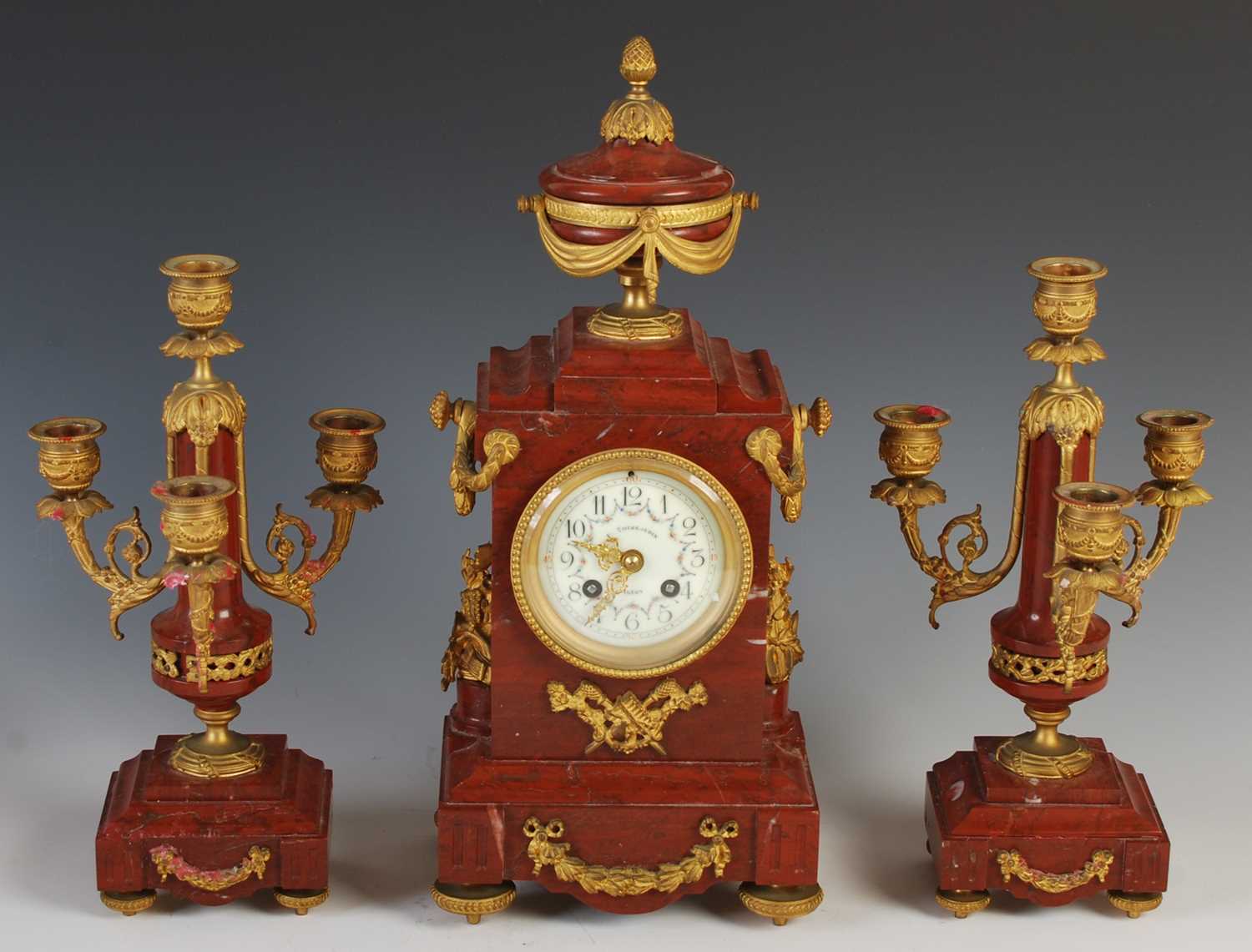 A late 19th century French marble and gilt metal mounted clock garniture, the clock with circular