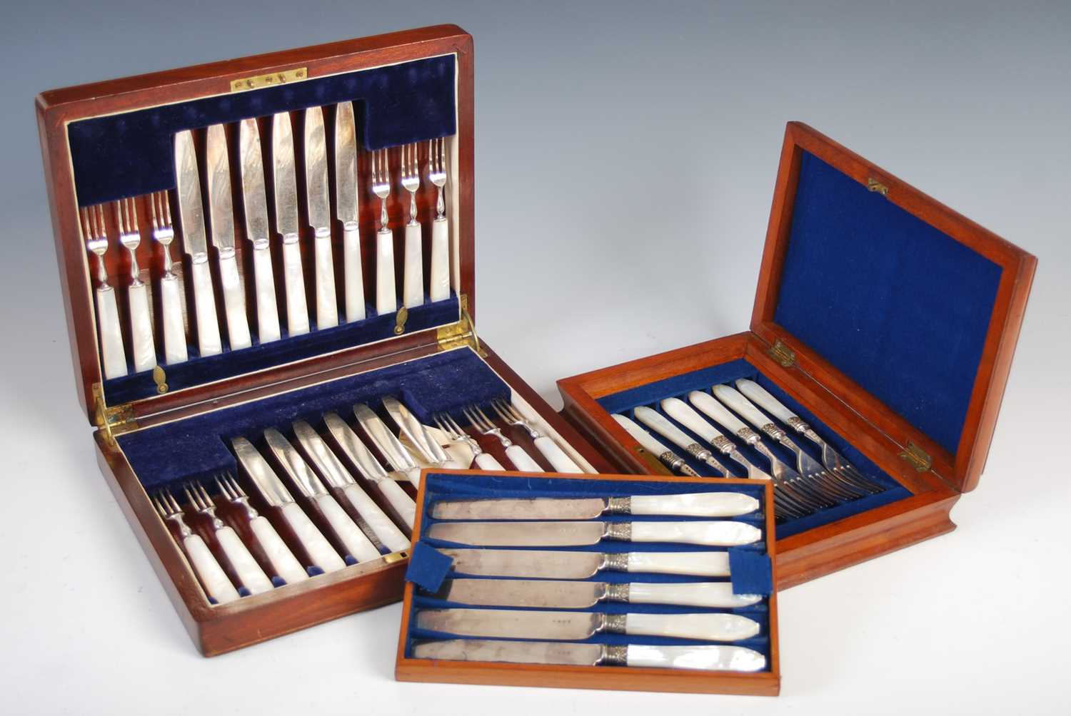 A set of six silver plated mother-of-pearl handled fruit knives and forks, makers mark of JR&S, in