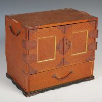 A Japanese lacquer jewellery cabinet with fine straw basket-weave finish, with twin doors with