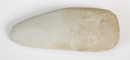 A Neolithic polished stone hand axe, 11.5cm long.