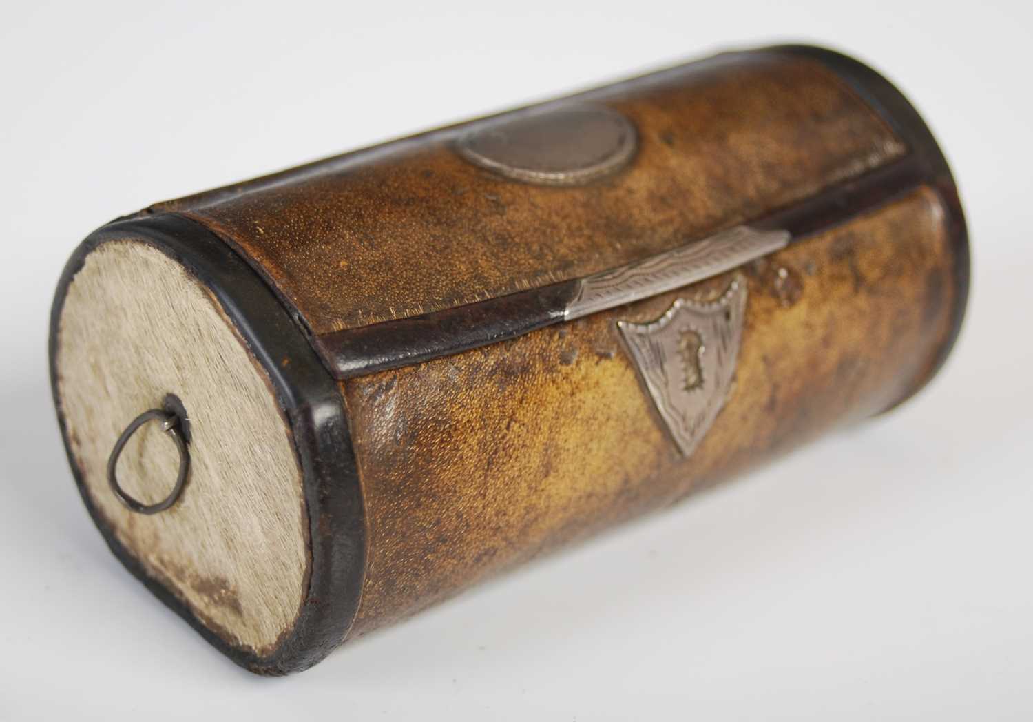 A leather cylindrical snuff box in the form of a travelling trunk, with leather integral hinge,
