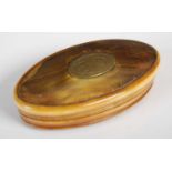 A horn oval snuff box, the detachable cover with oval brass plaque engraved with initials ‘EO’, with