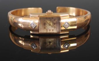 A vintage ladies yellow metal and diamond set Liga bangle watch, the rectangular dial with Arabic