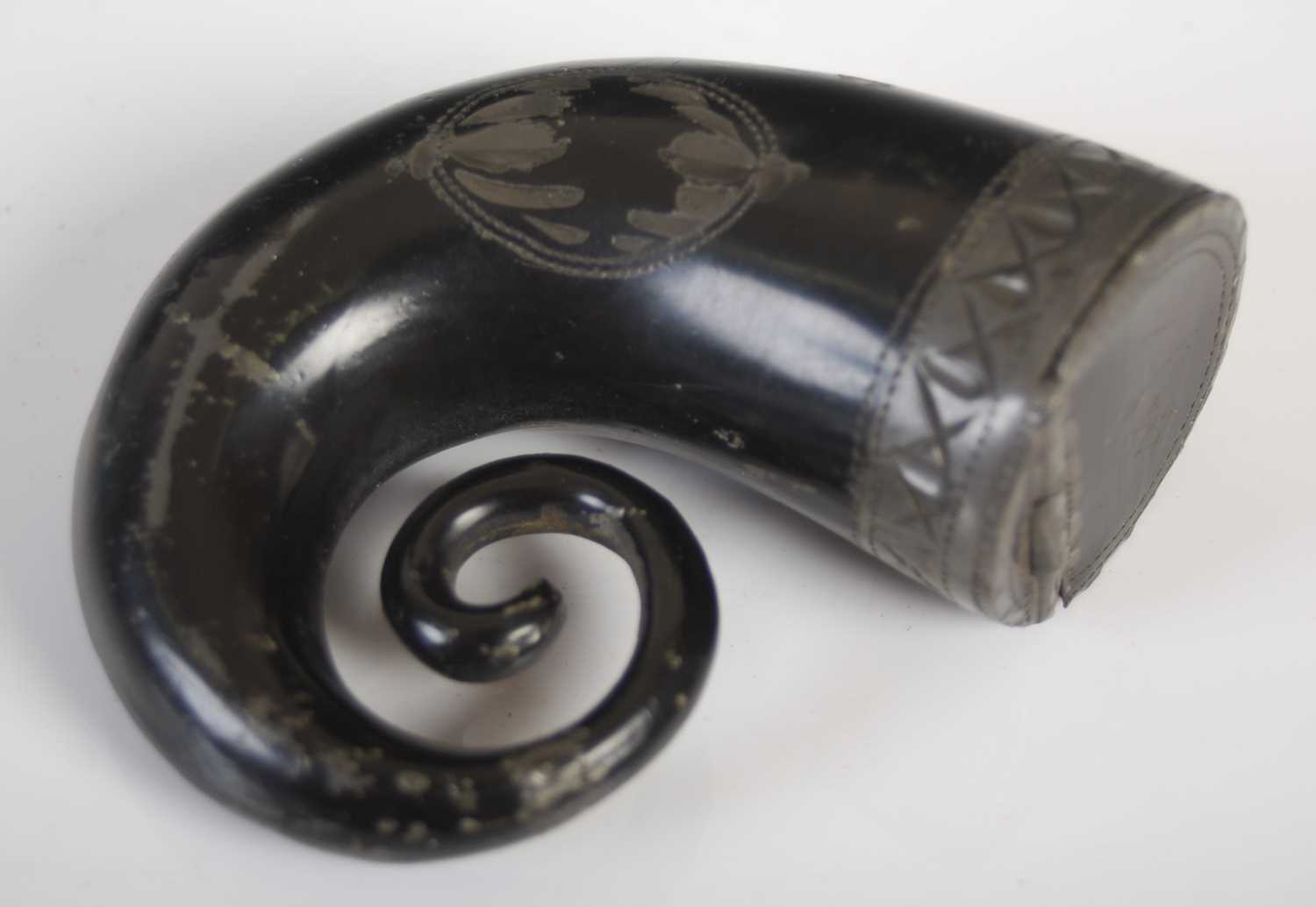 A pewter snuff mull in the form of a ‘curly horn’ with black lacquer surface and bright-cut