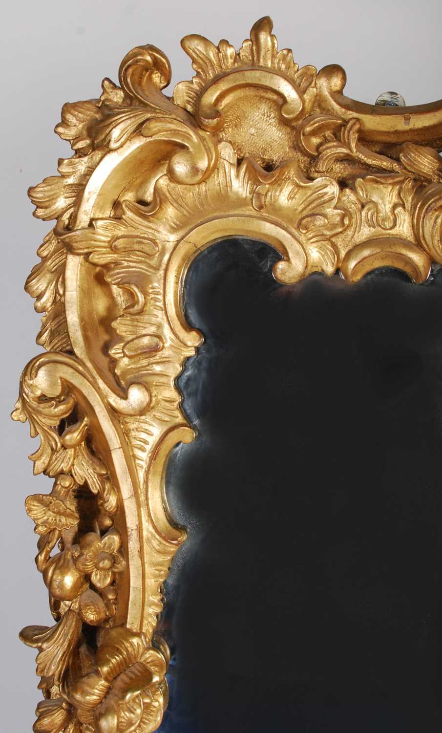 A 19th century carved giltwood over mantel mirror, the frame carved with scrolls, flowers and - Image 2 of 5