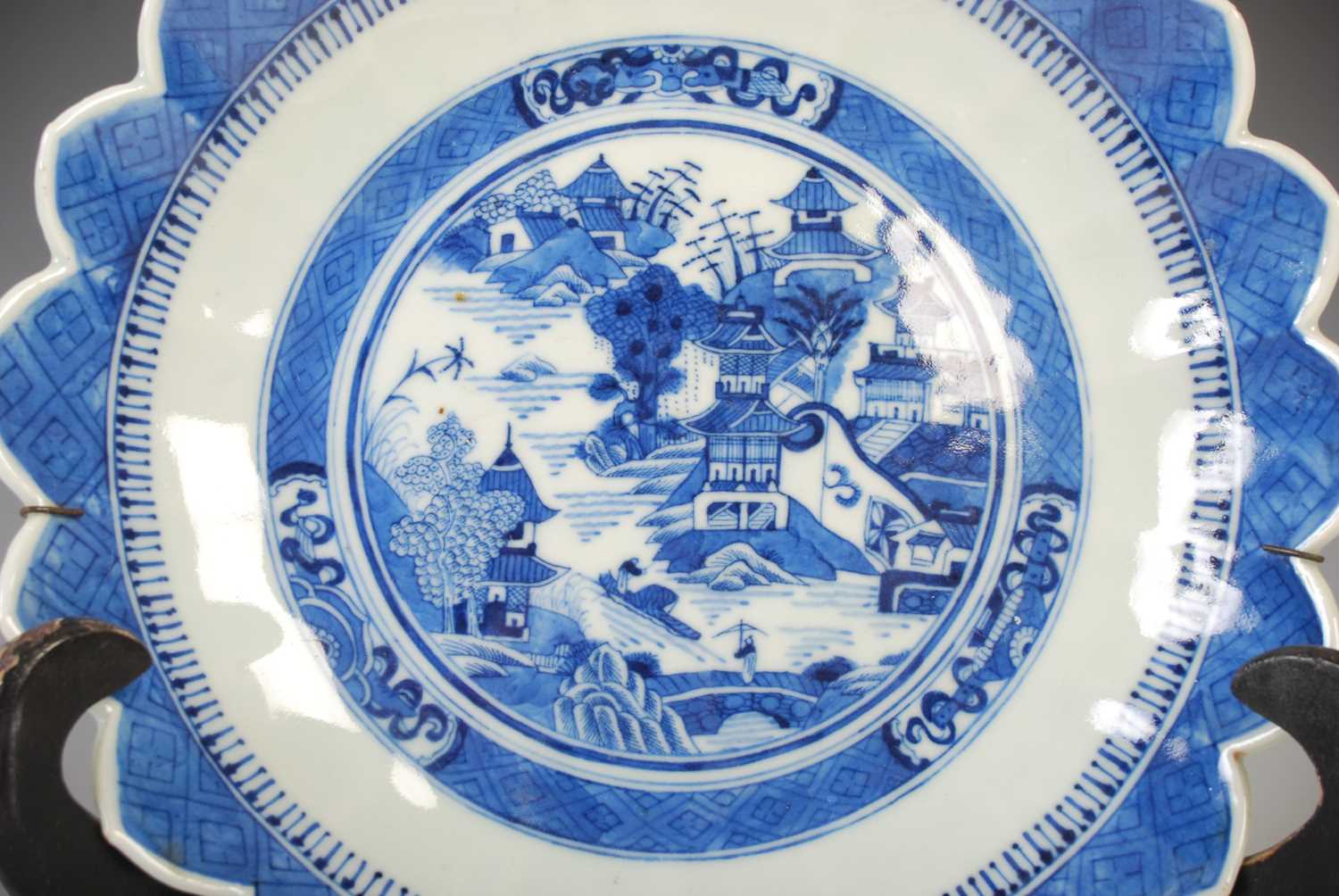 A Chinese porcelain blue and white flower shaped dish, Qing Dynasty, decorated with pavilions in a - Image 2 of 4