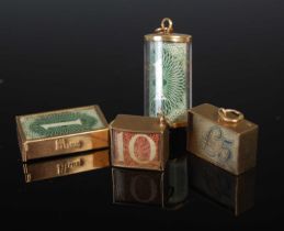 A collection of four assorted 9ct gold banknote charms, comprising one cylindrical 26.6mm long and