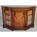 A 19th century walnut, marquetry and gilt metal mounted credenza, the shaped top above a plain