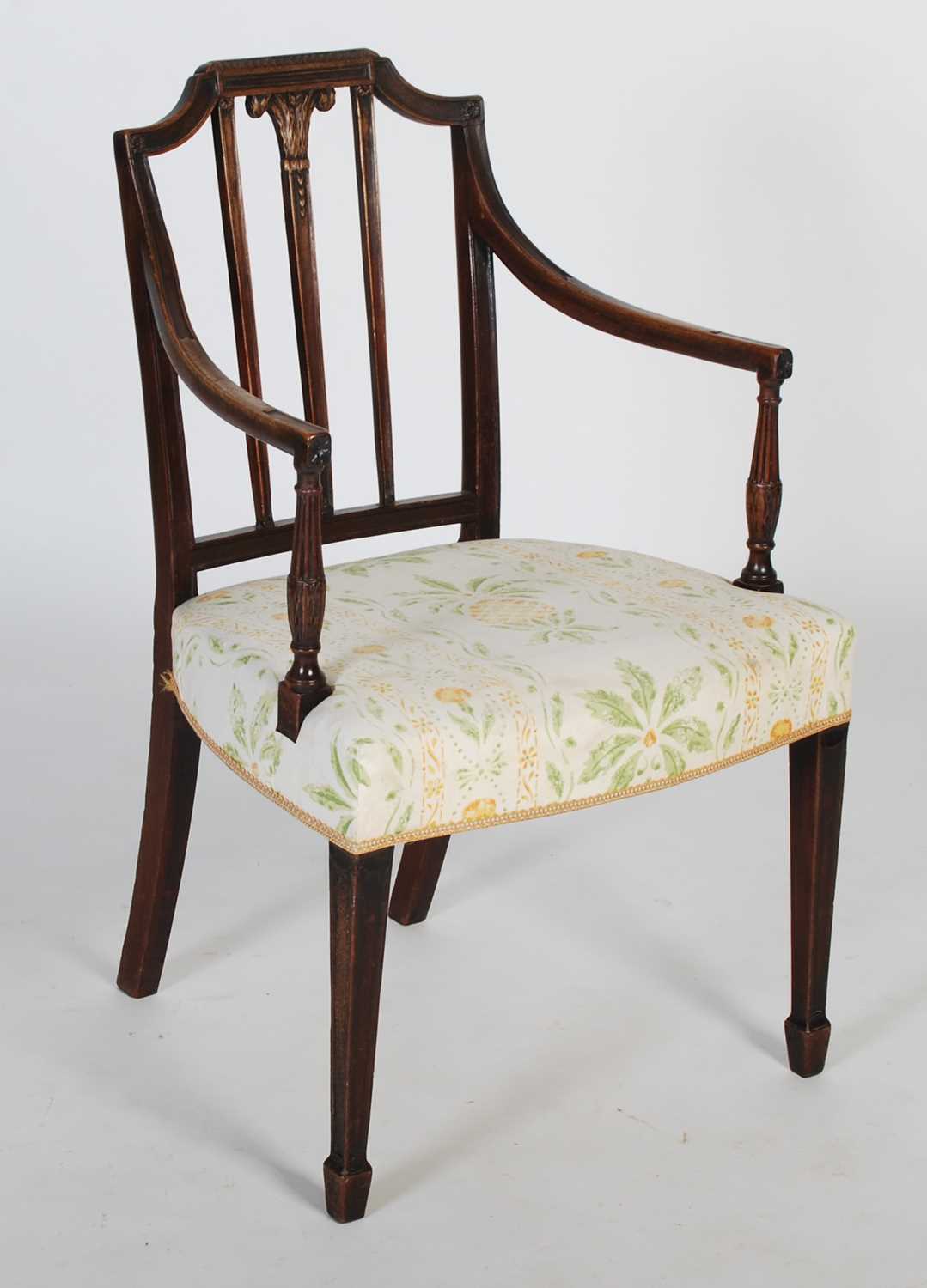 A George III mahogany elbow chair, the shaped top rail above a rectangular back with central
