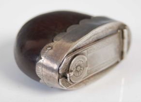 A silver-mounted nutshell snuff box with intricate silver hinged cover, the catch with rotating