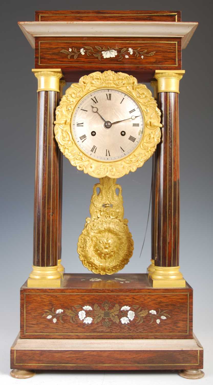 A French Charles X rosewood and brass inlaid Portico clock, the engine turned silvered dial with