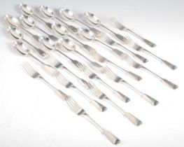 A composite suite of Victorian silver flatware, fiddle pattern, comprising twelve dessert forks,