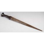 A 17th / 18th century Scottish dirk, the single edged blade and carved wood handle decorated with