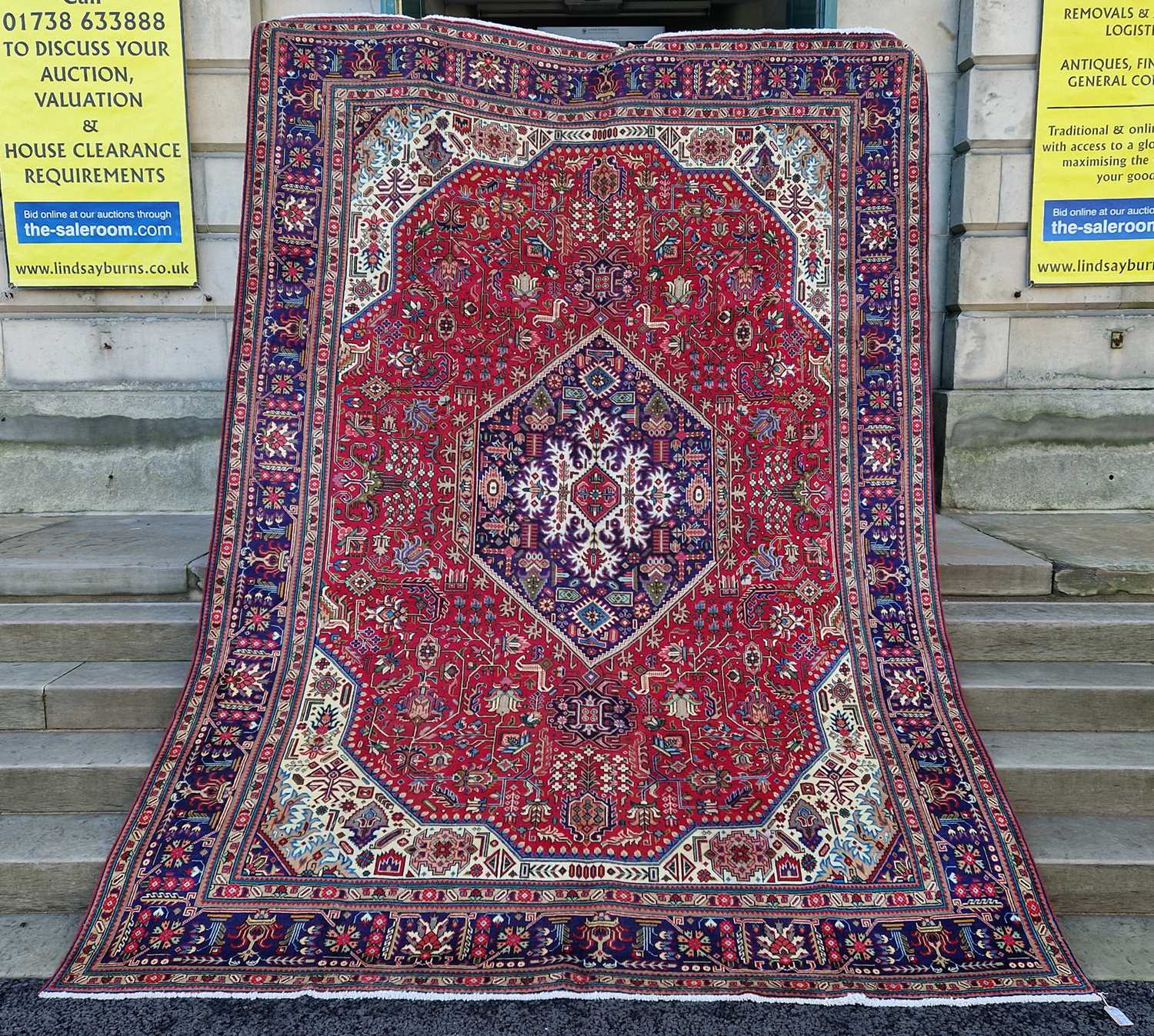 A Persian Tabriz carpet, 20th century, the rectangular madder field centred with a blue ground - Image 2 of 6