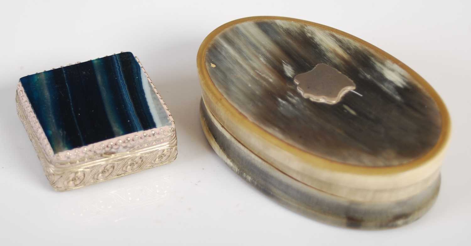 A late 19th century oval shaped horn snuff box and cover, the detachable cover centred with a