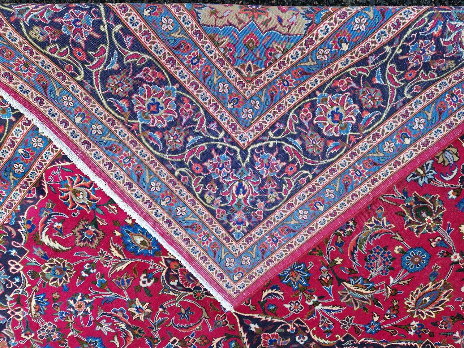 A Persian Mashad carpet, 20th century, the rectangular magenta ground centred with a blue lozenge - Image 3 of 5