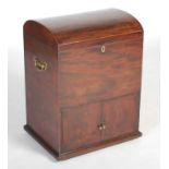 A George III mahogany and boxwood lined dome top cellarette, the hinged cover opening to a fitted