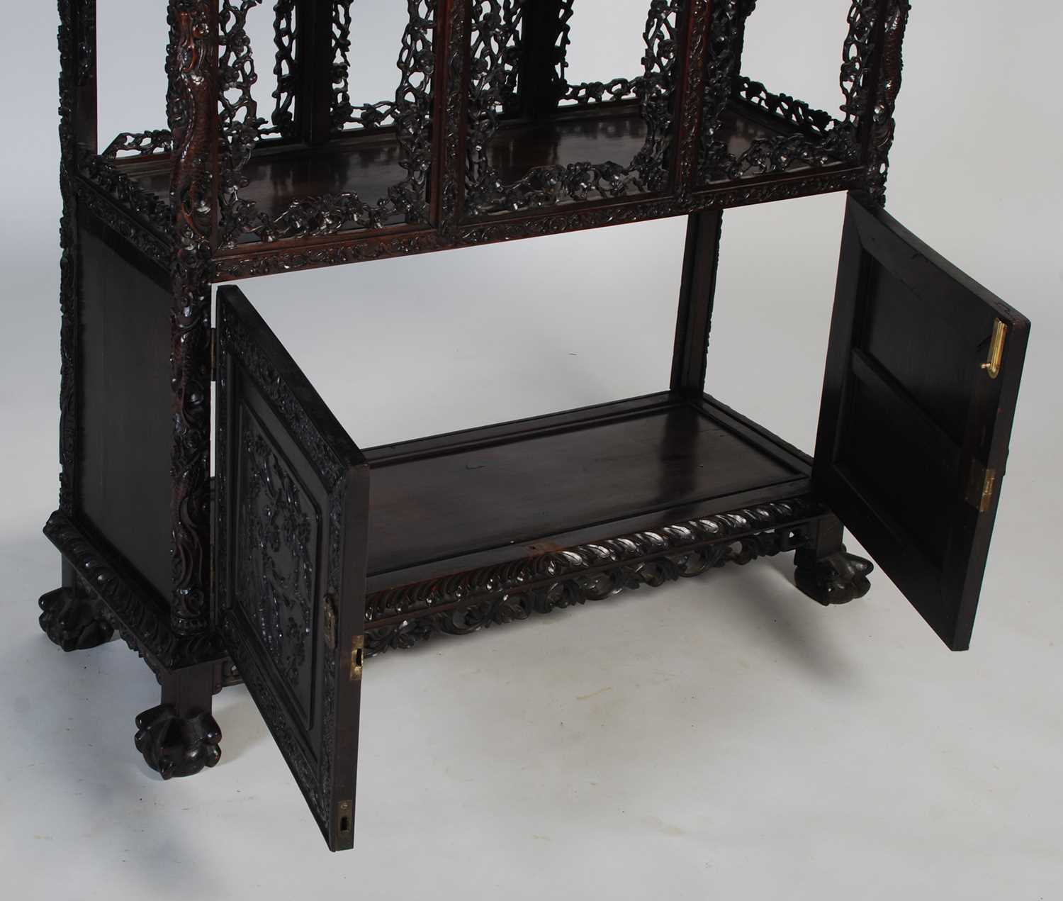 A late 19th century Chinese dark wood open display cabinet, with carved and pierced surmount of - Image 7 of 8