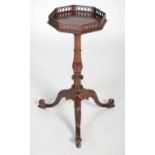 A George III mahogany kettle stand, the octagonal shaped top with pierced gallery and pull-out