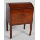 A 19th century mahogany cellarette, the hinged domed top opening to a fitted interior with twelve