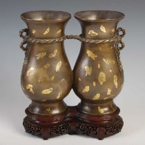 A Chinese gold-splashed bronze double vase, Qing Dynasty, formed as two tied vases, impressed seal