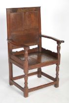 A rare early 18th century Welsh oak wainscot elbow chair, circa 1700, the triple panel rectangular