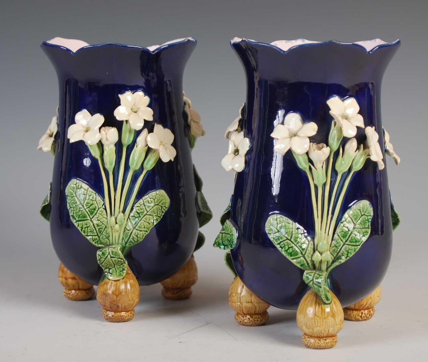 A pair of Minton Majolica pottery vases, dated 1866, decorated in relief with three white petalled