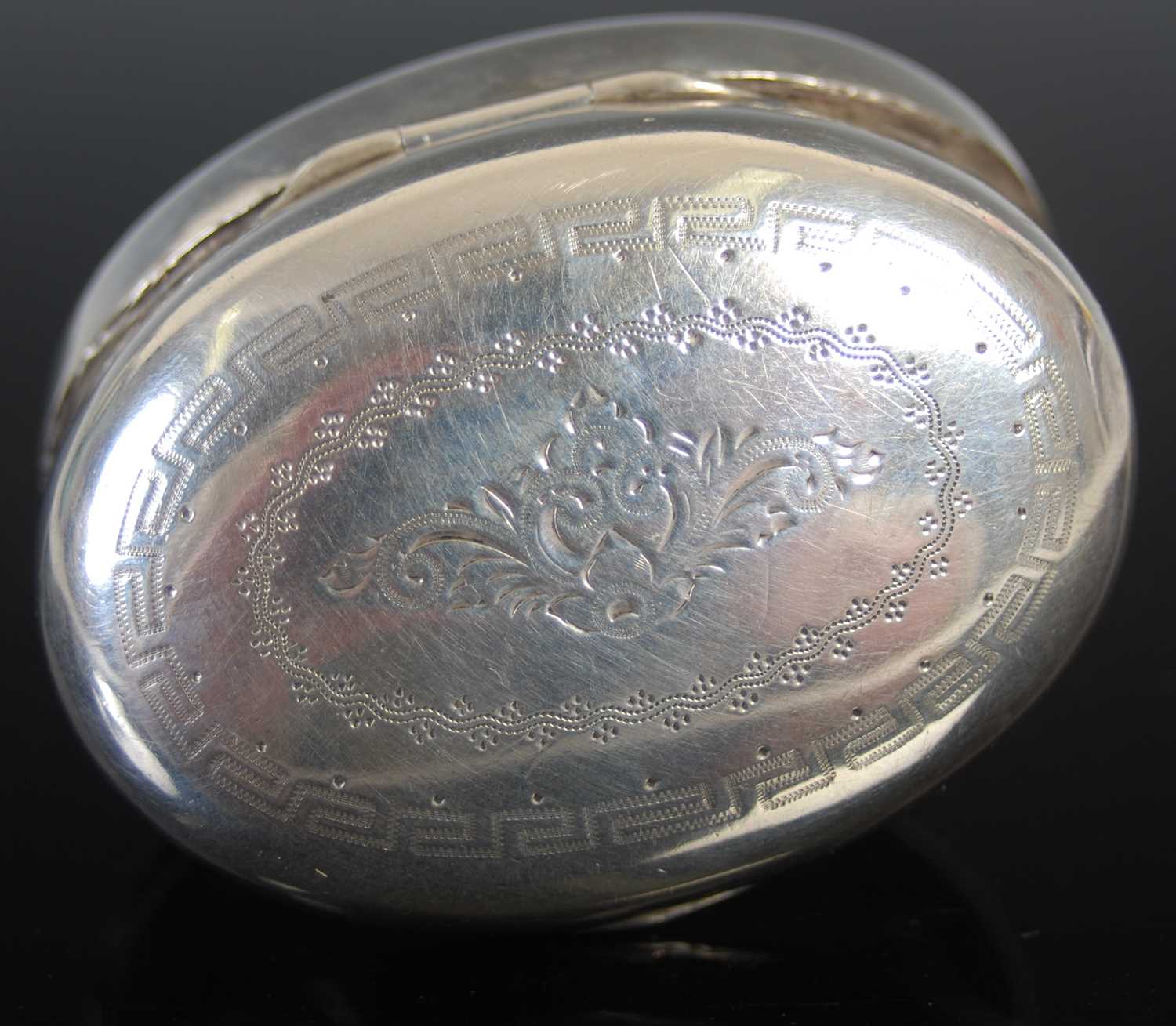 A 19th century Dutch silver oval cachou box, engraved with a floral spray, with ‘snap-fitting’ - Image 3 of 4