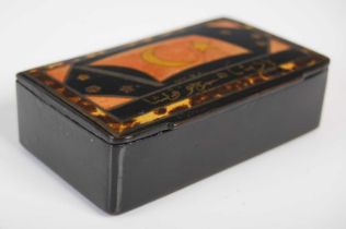 A black lacquer papier-mâché oblong snuff box, the hinged cover painted with a flag, star and