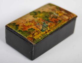 A black lacquer papier-mâché oblong snuff box, the hinged cover painted with a rural scene with four