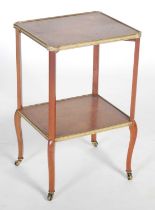 An Edwardian satinwood, ebony lined and brass mounted two-tier étagère, the rectangular top with