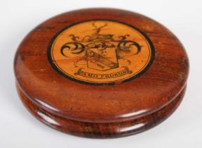 A treen circular snuff box in finely grained polished wood with central sycamore disc, with