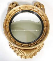 A Regency style giltwood convex wall mirror, with ball-set frieze, two scroll surmounts and